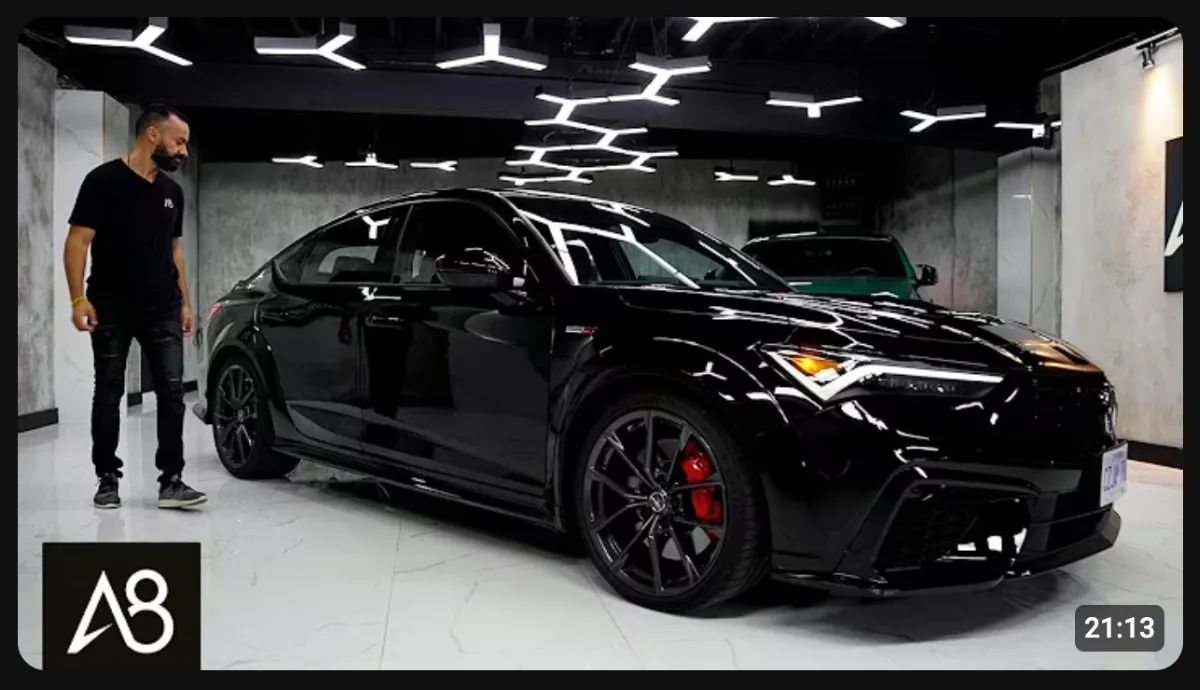 Automotive YouTube thumbnail featuring a black luxury sports car in a modern showroom